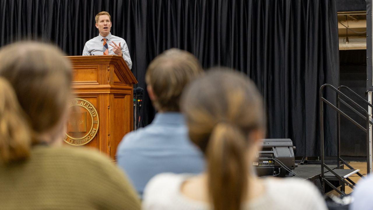 pastor speaking to a group of students